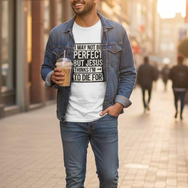Man walking on a city street holding a coffee cup, wearing a denim jacket and jeans.