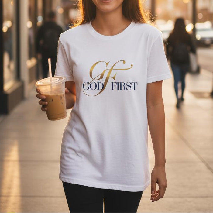 Woman walking on a sidewalk holding a drink, wearing a white t-shirt with 'GF First' text.