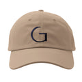 Beige cap with a navy blue 'G' logo on a white background