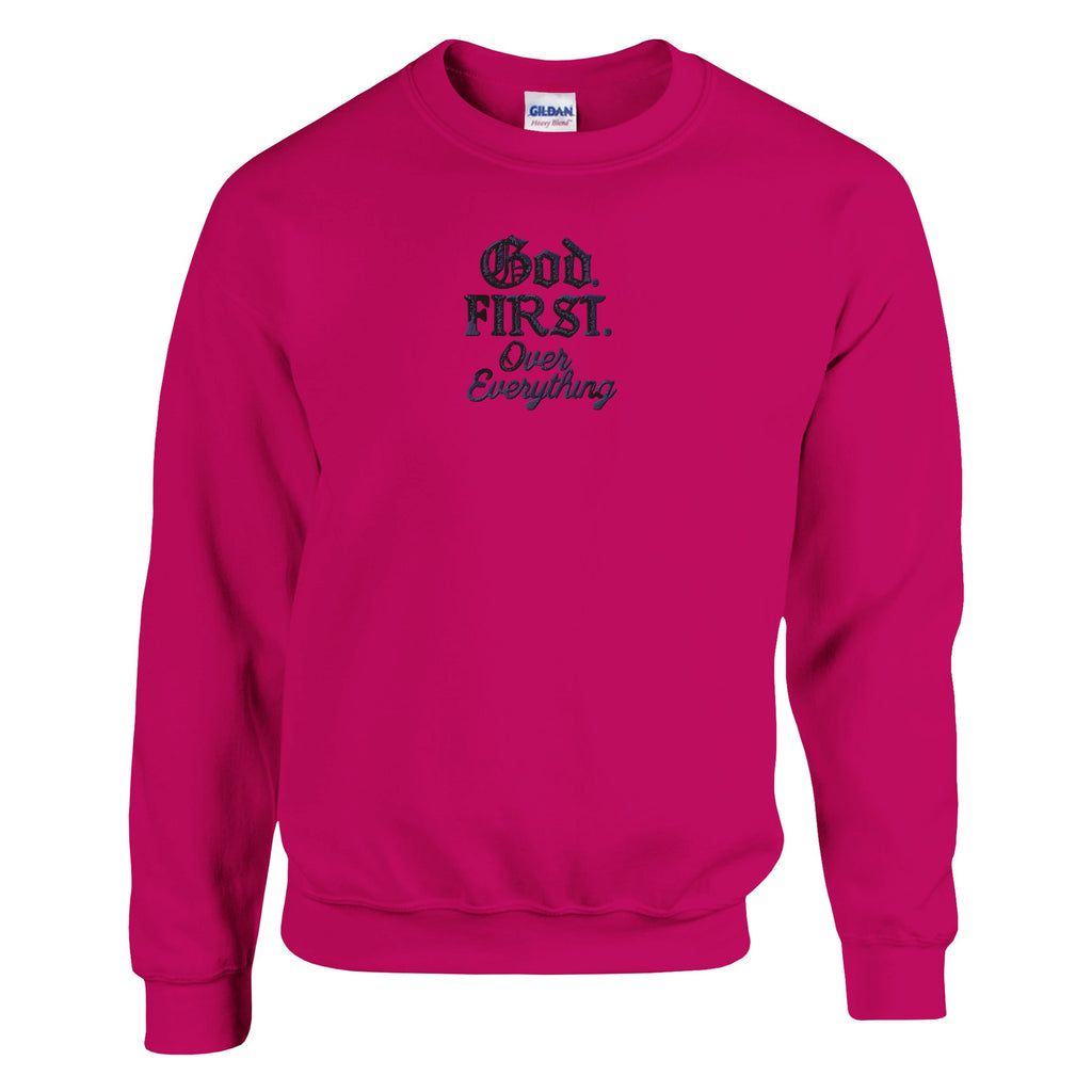 Pink sweatshirt with text 'God First Over Everything' on a white background