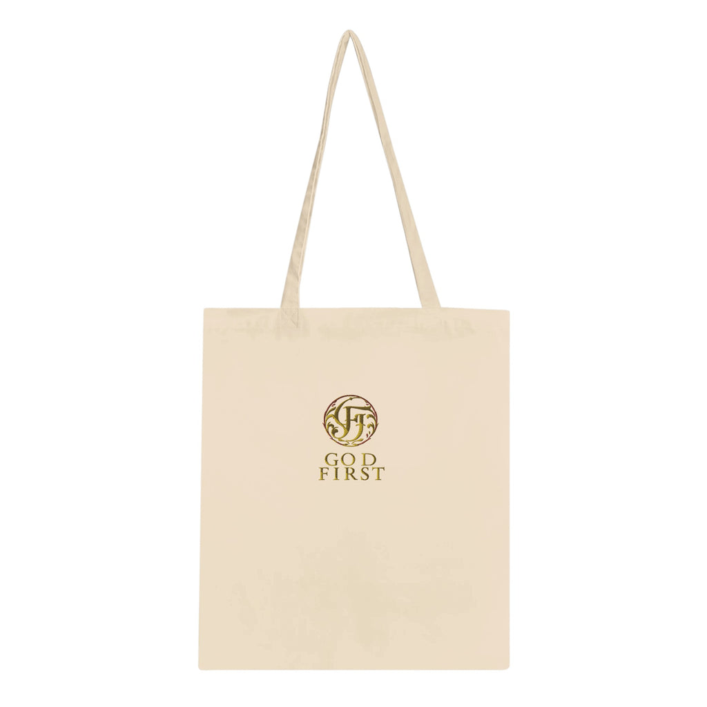 Beige tote bag with gold logo and text on a white background