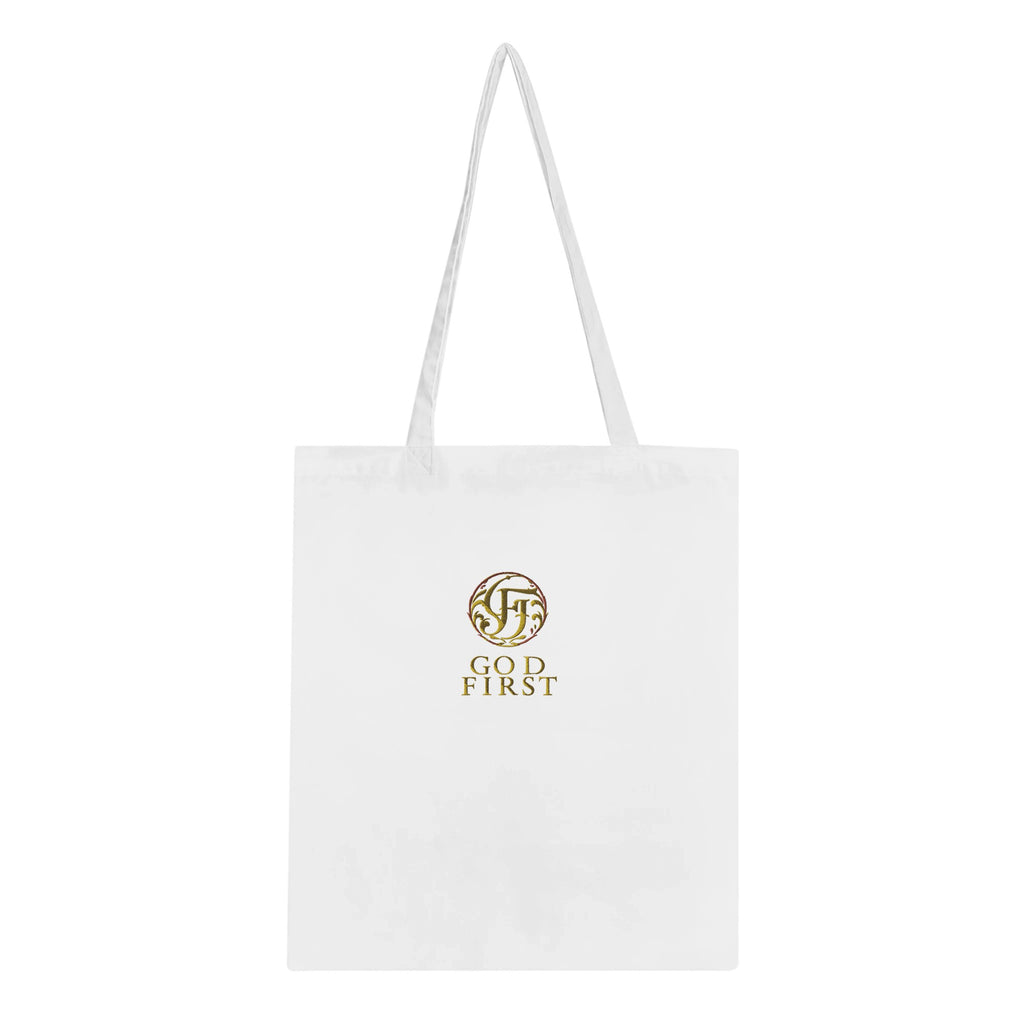 White tote bag with gold logo and text on a white background