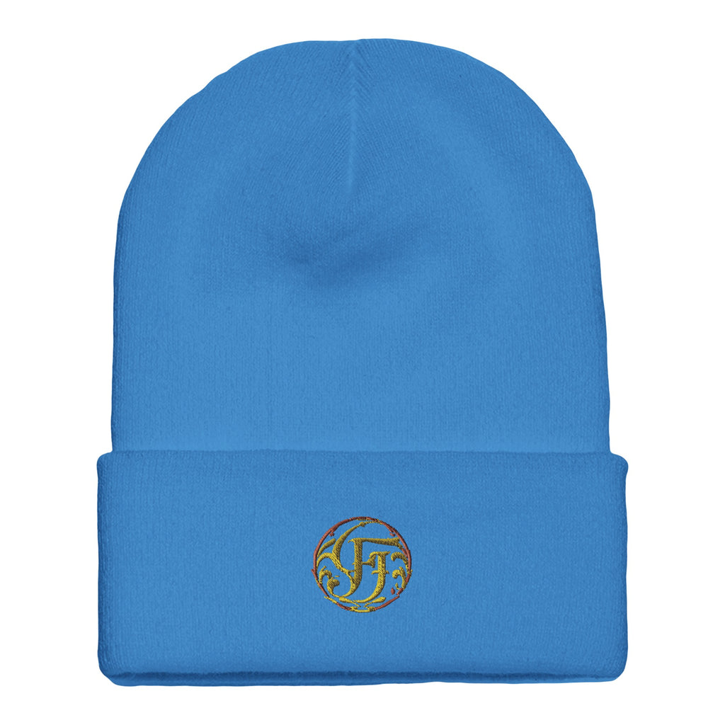 Blue beanie with a logo on the cuff against a white background