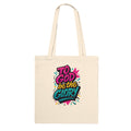 Beige tote bag with colorful 'To God be the Glory' text design on a white background