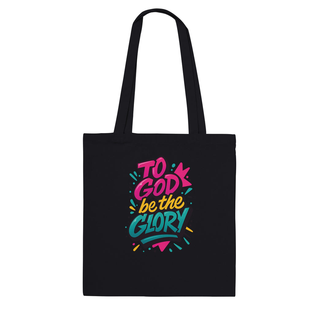 Black tote bag with colorful 'To God be the Glory' text design on a white background