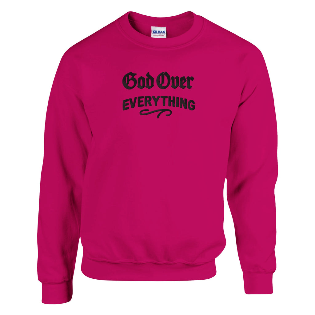 Pink sweatshirt with 'God Over Everything' text on a white background