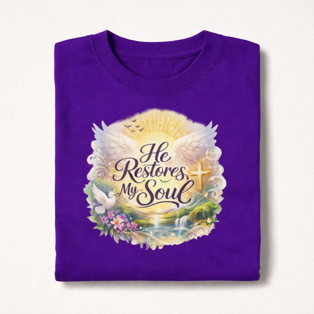 Purple t-shirt with a nature-themed design and text 'He Restores My Soul' on a white background