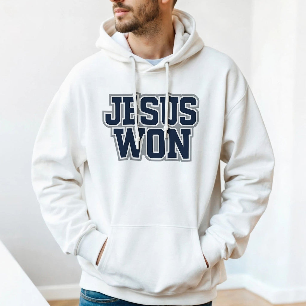 Man wearing a white hoodie with 'Jesus Won' text indoors.
