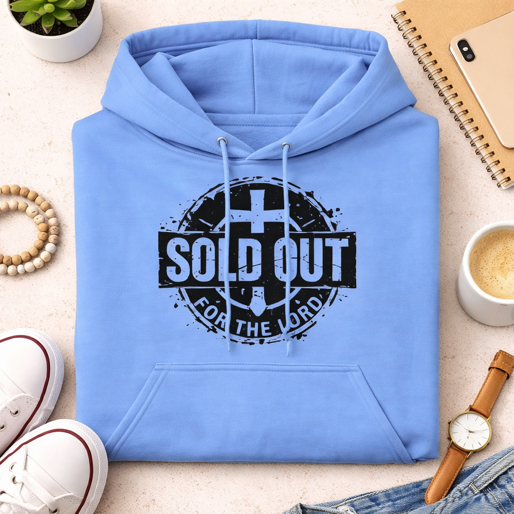 Light blue hoodie with 'SOLD OUT FOR THE LORD' text on a light surface with accessories.