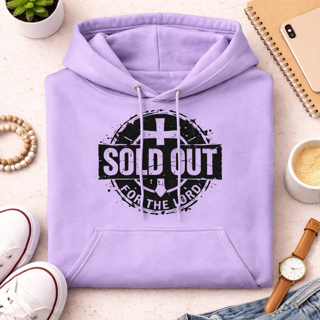 Purple hoodie with 'SOLD OUT FOR THE LORD' text on a light surface with accessories.