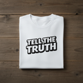 White t-shirt with 'Tell the Truth' text on a wooden surface