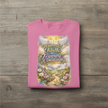 Pink t-shirt with a colorful graphic and text on a wooden surface