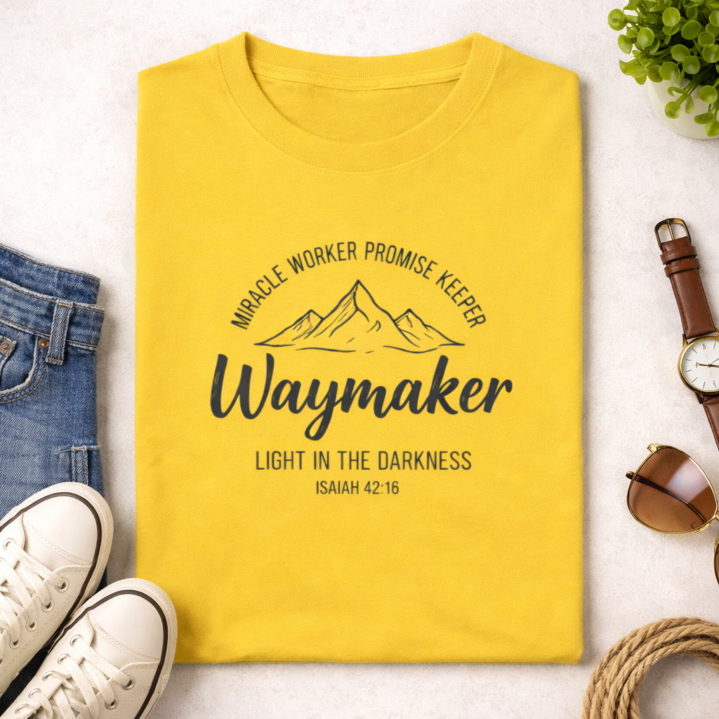 Yellow t-shirt with motivational text on a white surface with accessories around